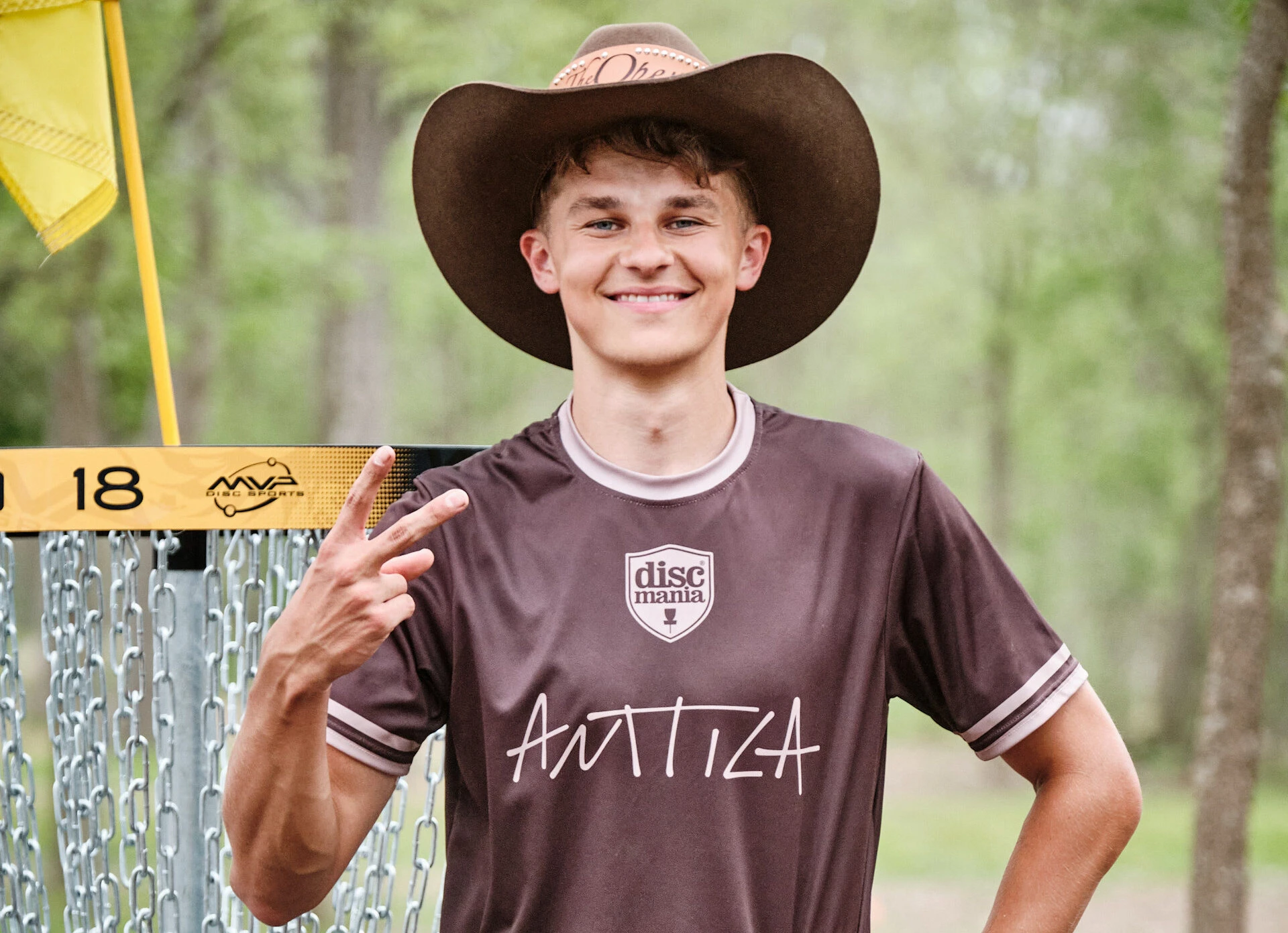 Niklas in the cowboy hat holding up two fingers