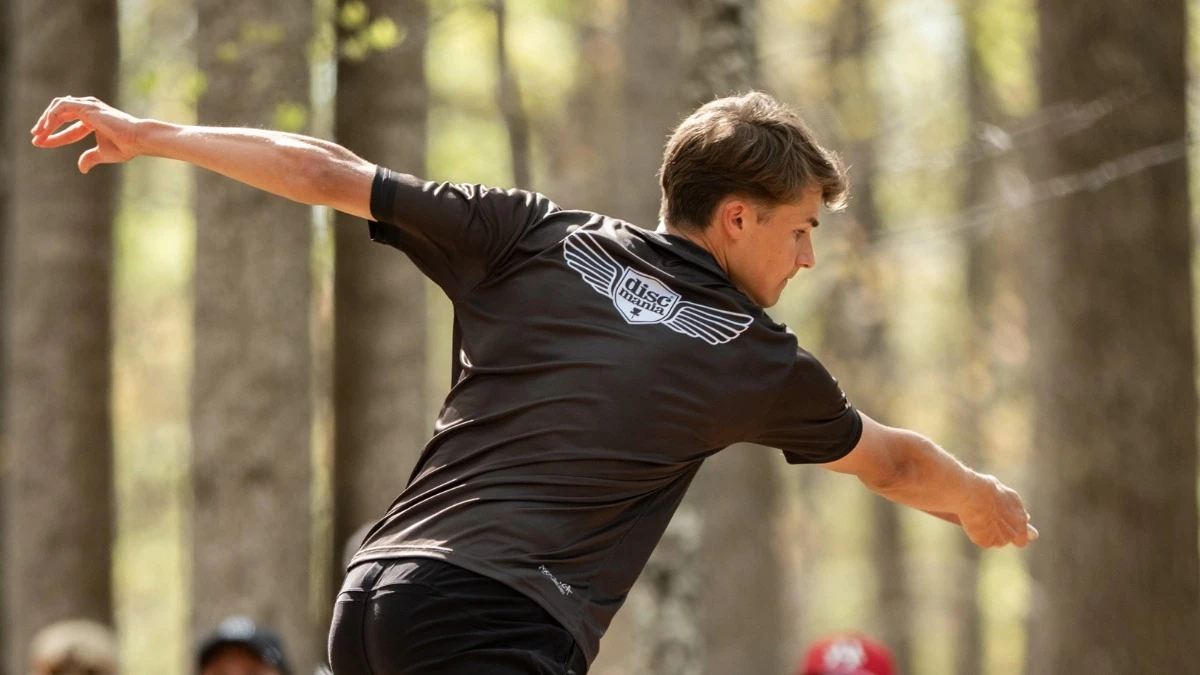 Follow-through of a drive seen from behind, Discmania wings on the jersey