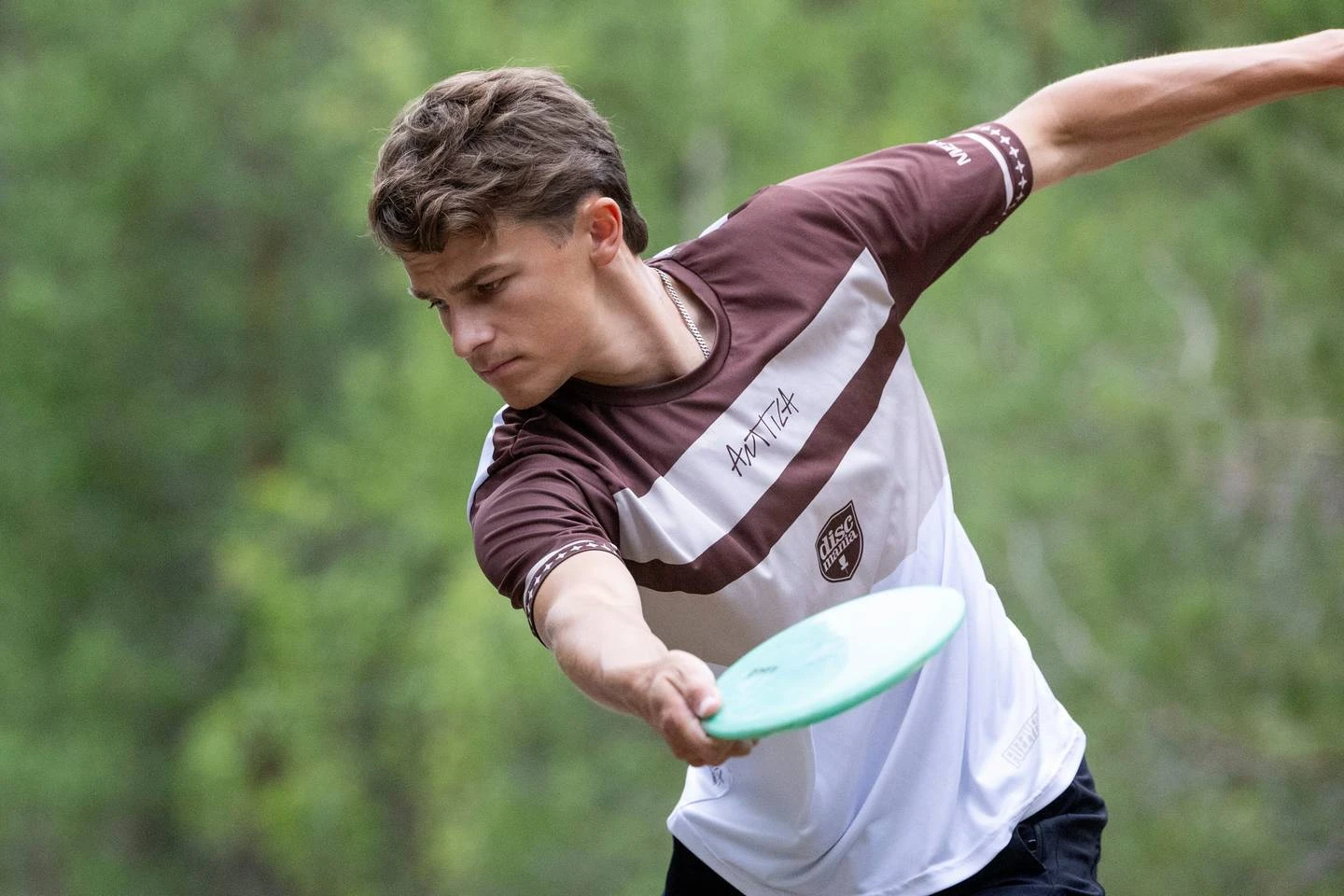 Niklas Anttila at full reach-back, about to release a backhand drive