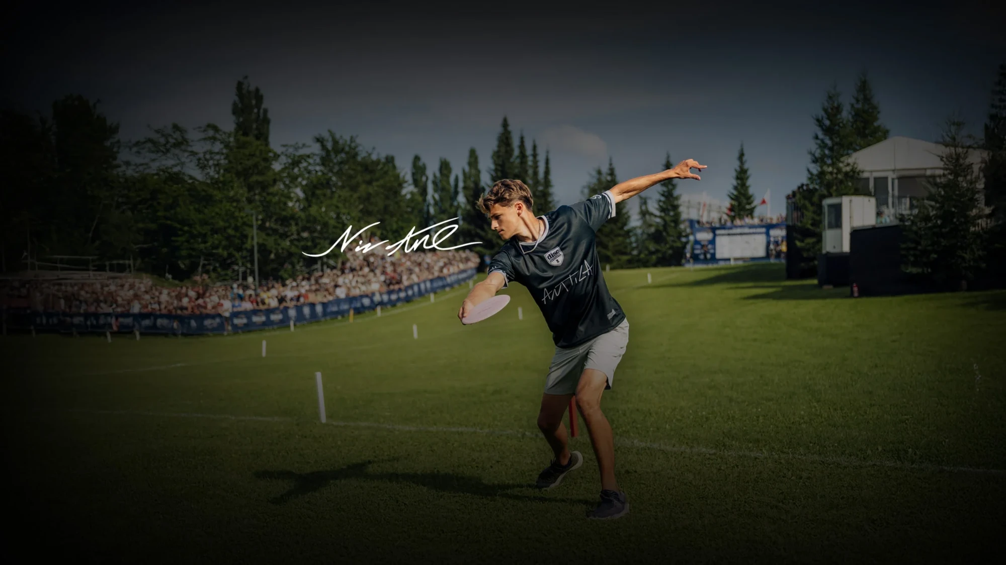 Niklas Anttila mid-drive on a fairway lined with a packed gallery